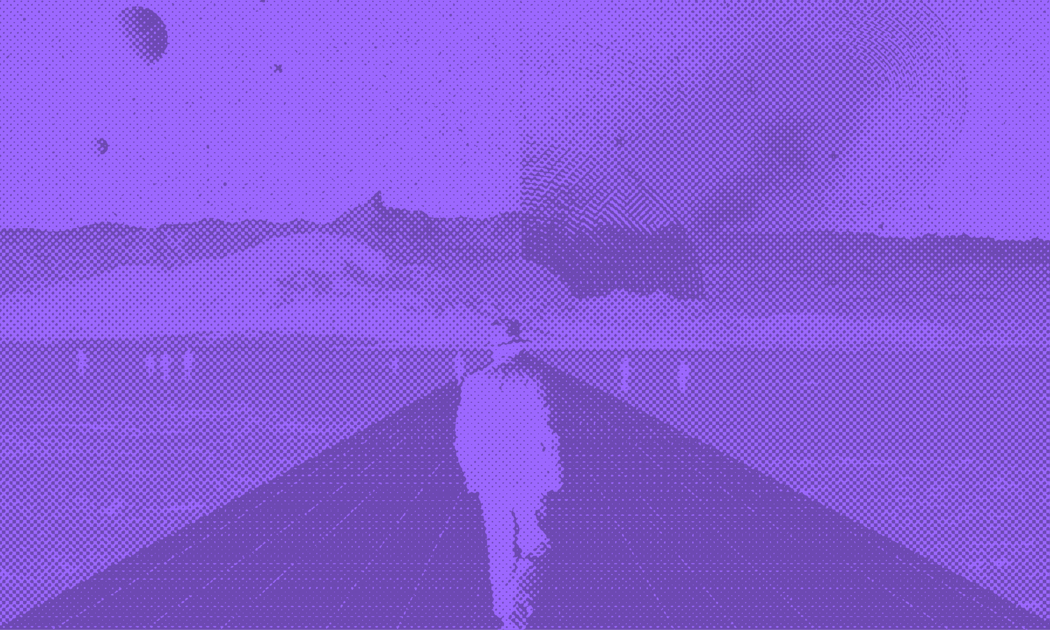 A man in a hat walking down a road